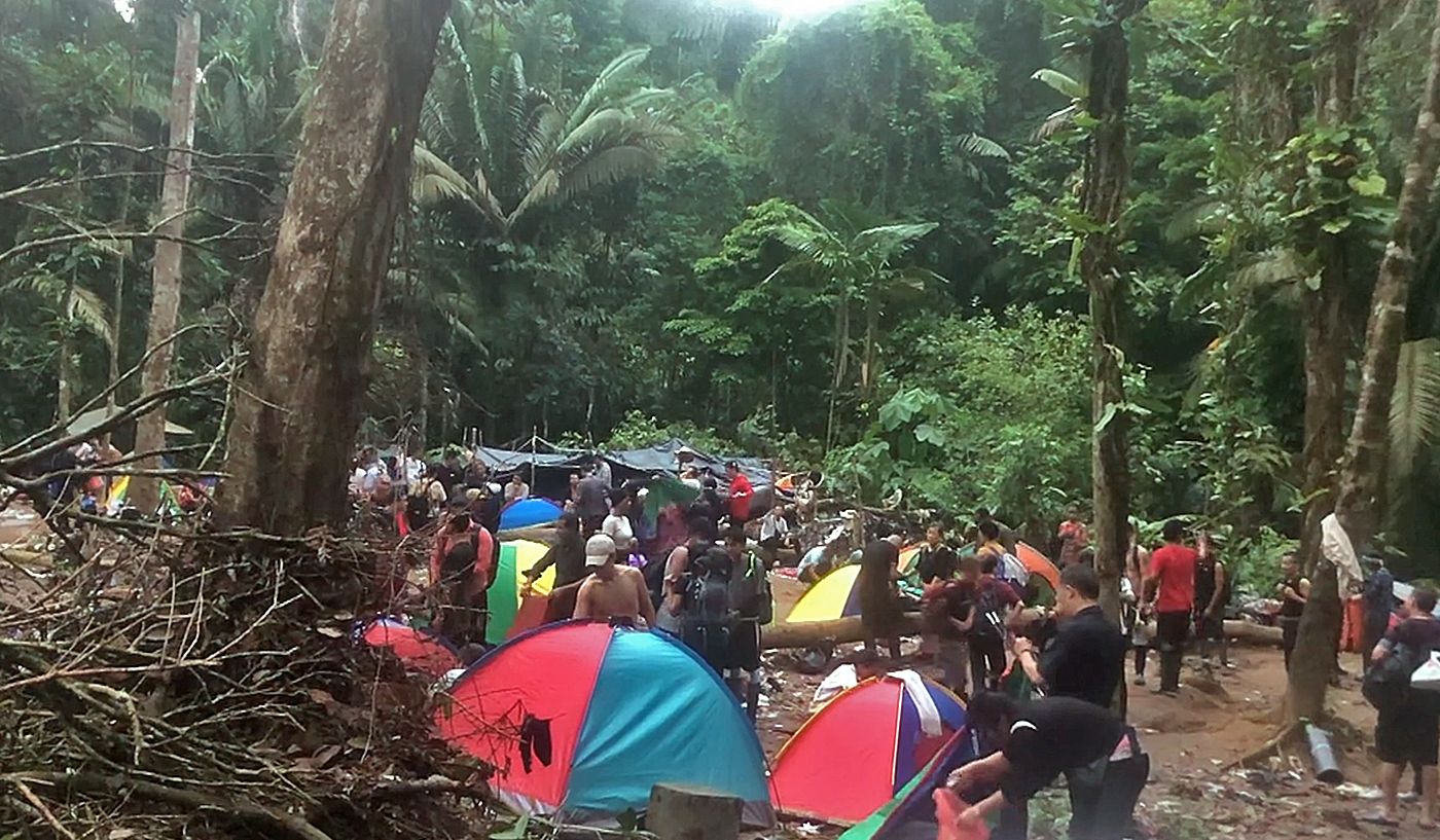 Migrants set up tents to camp overnight at a rest stop in the Darien Gap.