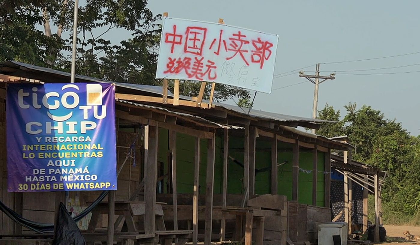 A small shop’s sign in Chinese states that it also offers currency exchange services for American dollars.