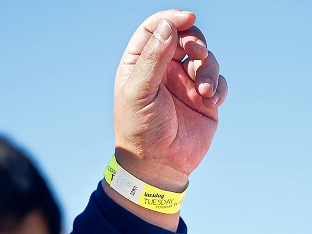 Migrants are given colour coded wristbands to mark which day they arrived at the US-Mexico border.