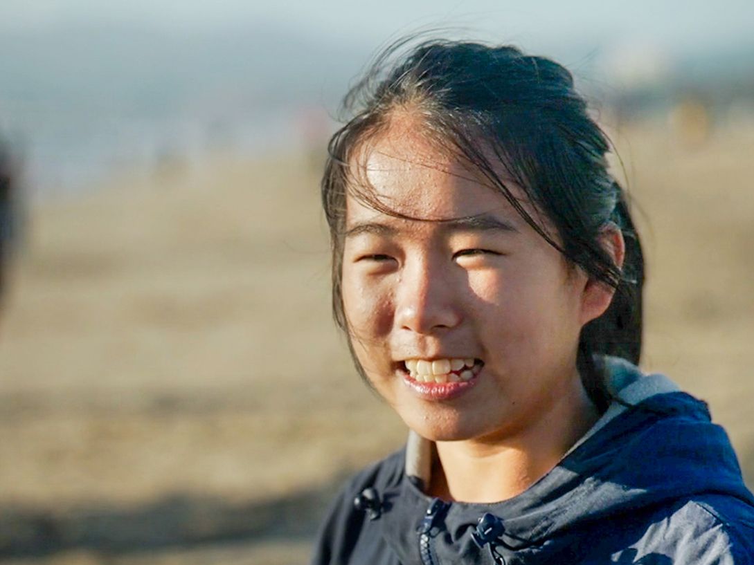 Lucy breaks into a smile during a lighthearted moment shared with her parents.